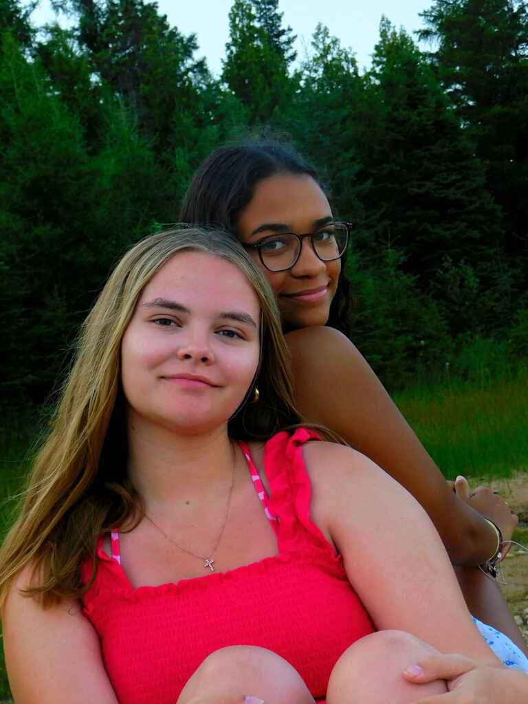 Two girls sitting back to back